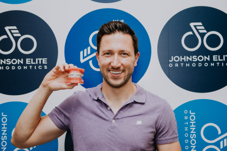 Guy holding model of teeth